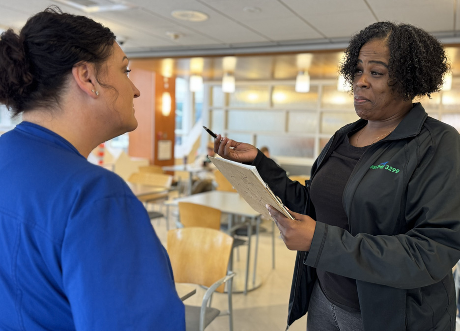 A volunteer helps getting signatures for support.